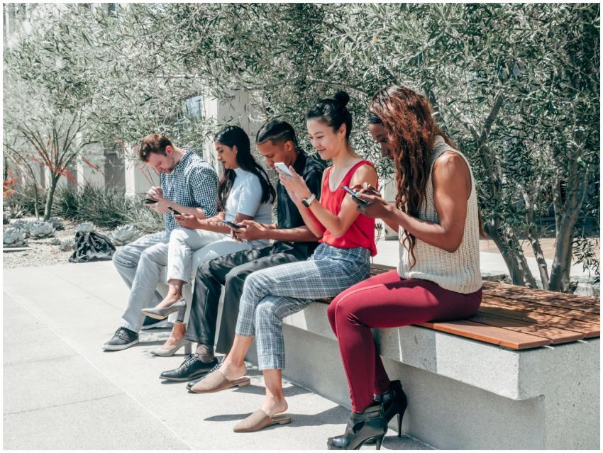 A diverse group of adults sitting outdoors, engros