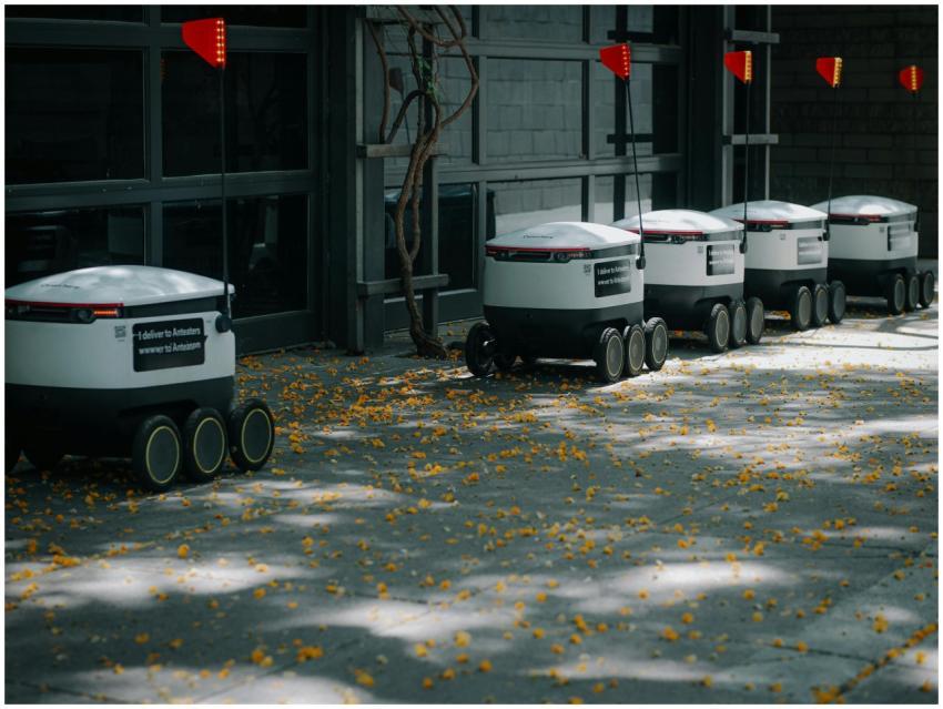 Autonomous delivery robots lined up outdoors showc