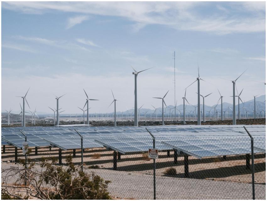A renewable energy farm with wind turbines and sol