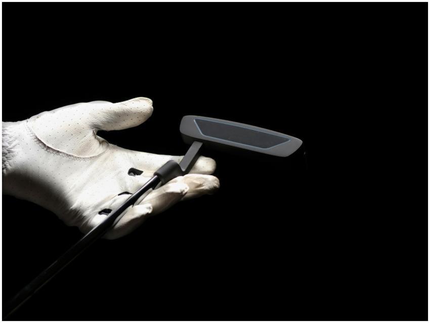 A close-up image focusing on a golf putter held by