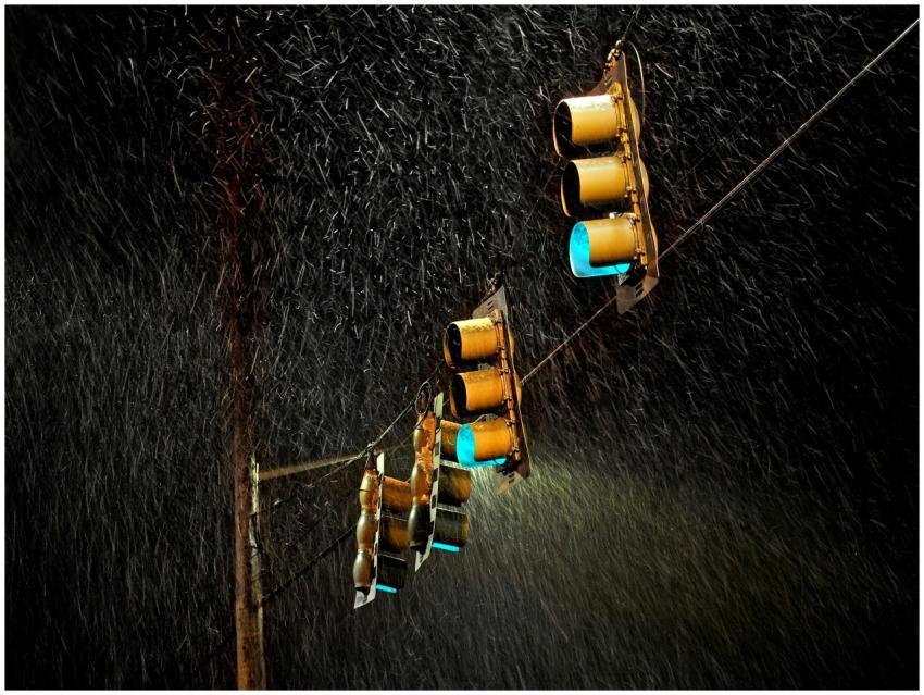 Traffic lights glowing in the rain with a long exp