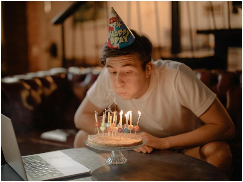 A man celebrates his birthday at home with a cake