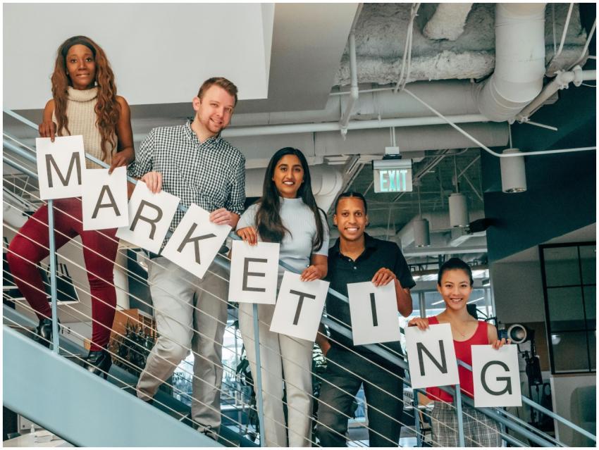 A diverse group of professionals holding a marketi