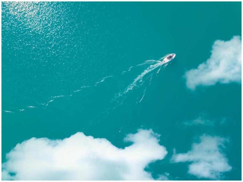 A motorboat glides across the stunning turquoise w