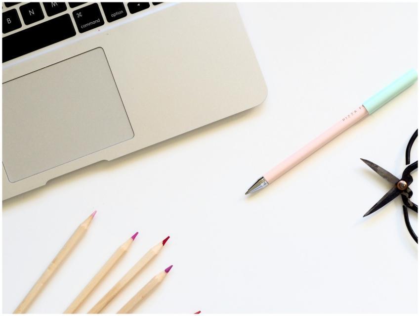 A clean minimalist desk setup featuring a laptop a