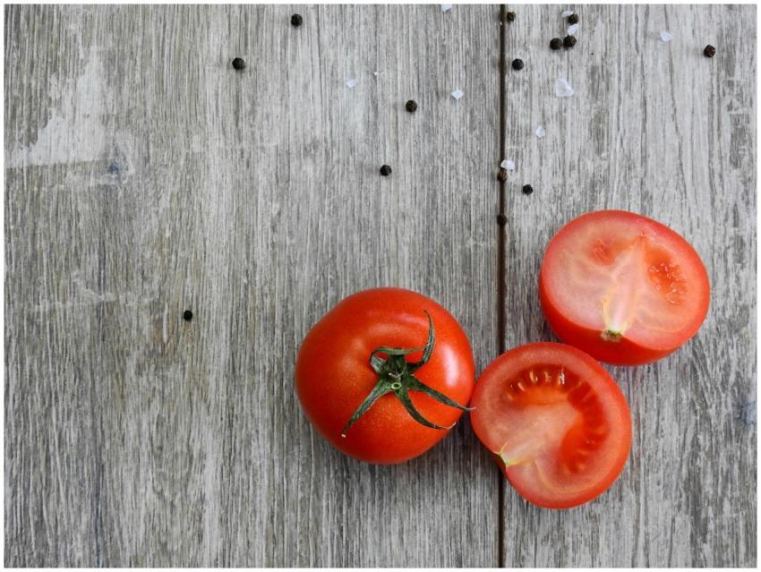 Close-up of ripe tomatoes on a rustic wooden table