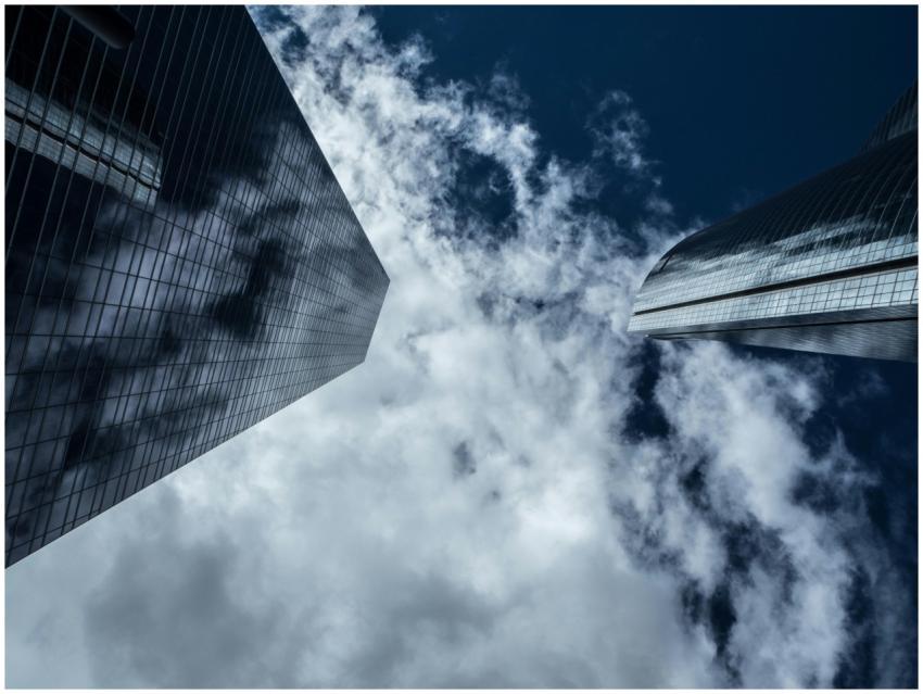 A low-angle shot of modern skyscrapers with reflec