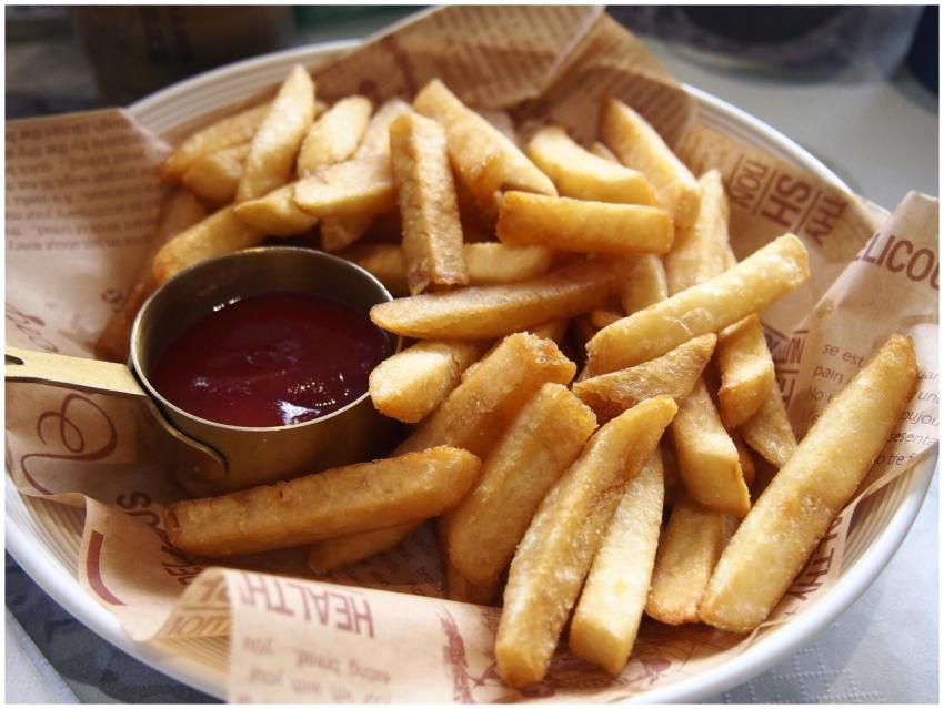 A plate of golden, crispy French fries served with