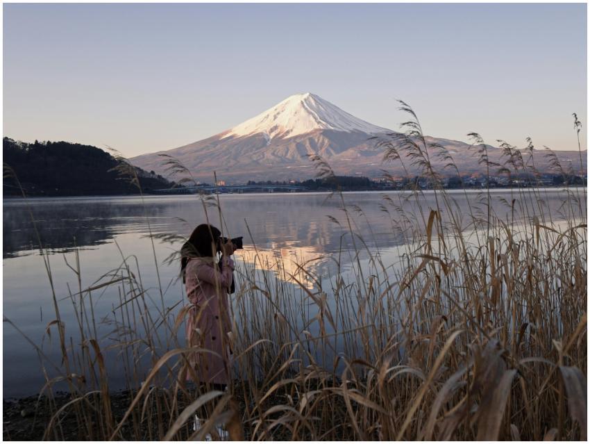 A woman captures the scenic beauty of Mount Fuji r