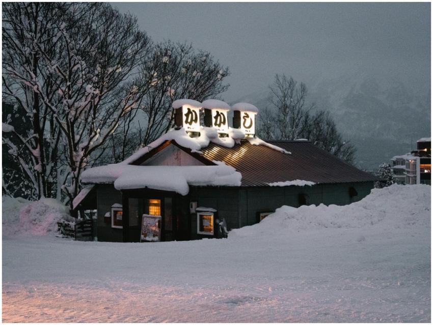 Snow-covered restaurant in snowy winter evening in
