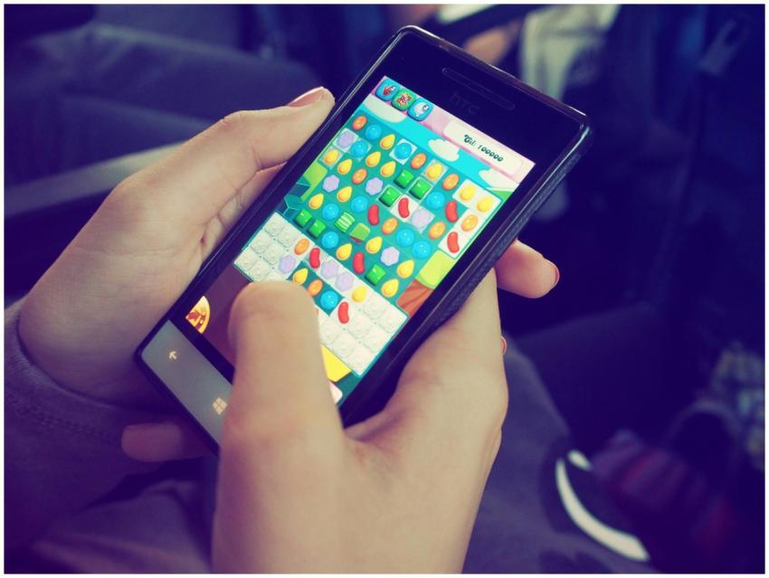 Hands holding a smartphone with a colorful puzzle