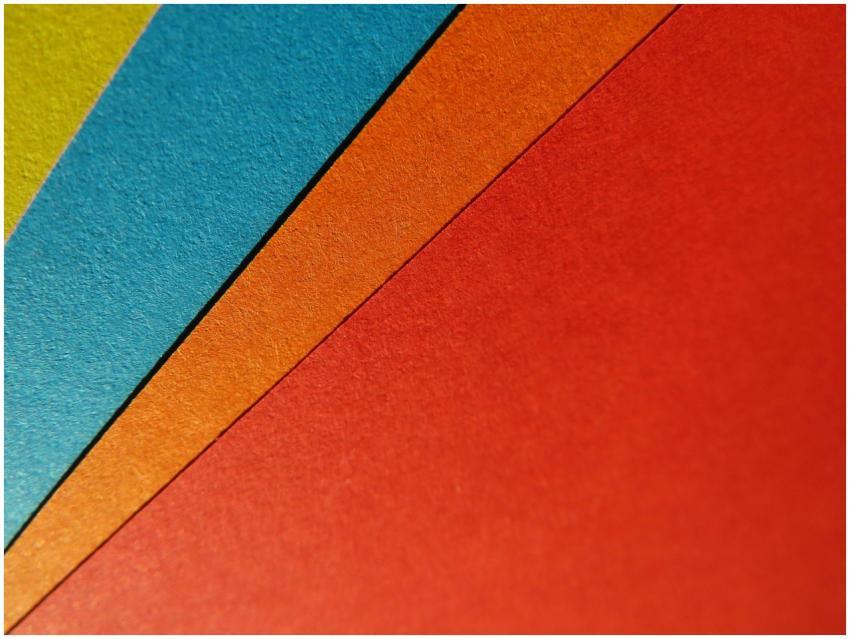 Close-up of vibrant, colorful paper sheets arrange
