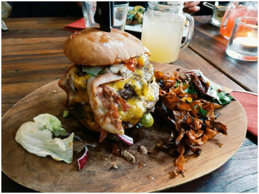 Mouthwatering cheeseburger topped with bacon, serv