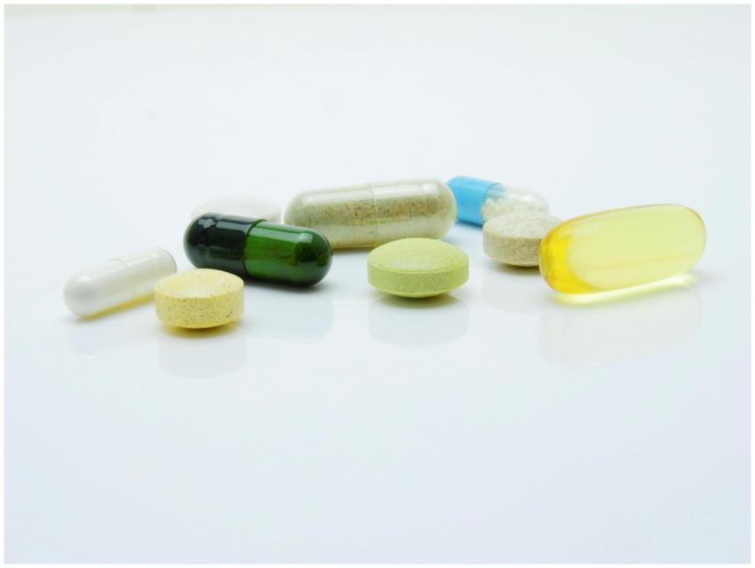 Close-up of various pills and capsules arranged on