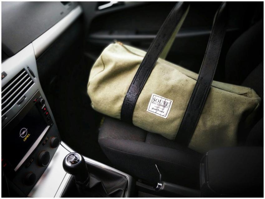 Stylish green canvas bag on a car seat displaying