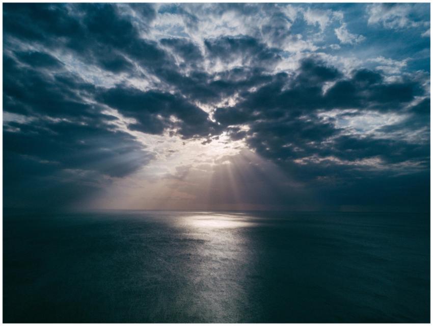 A breathtaking view of the ocean at sunset, with d