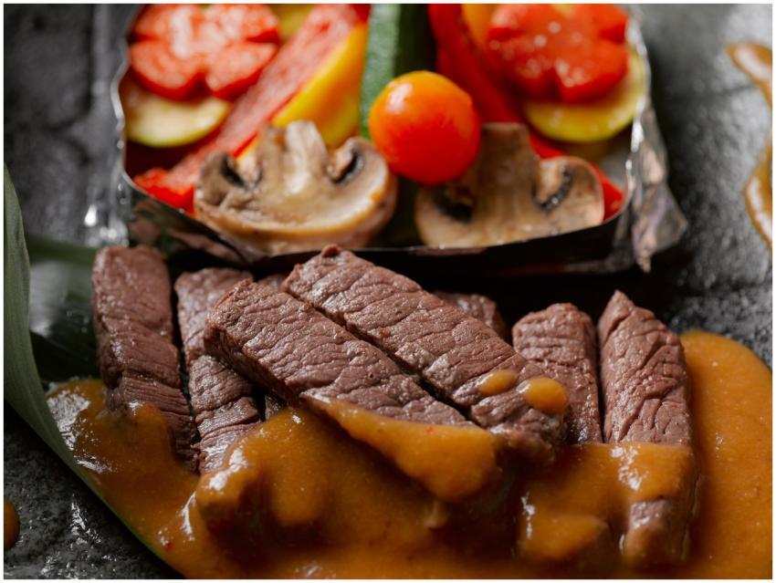 Succulent beef slices with savory sauce, paired wi