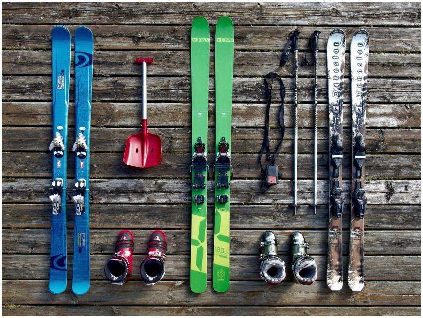 Collection of ski gear on a wooden deck, showcasin