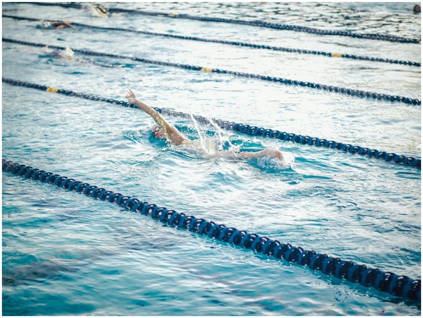 Swimmer practicing freestyle stroke in a lap pool,