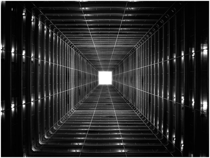 Black and white perspective of a tunnel leading to