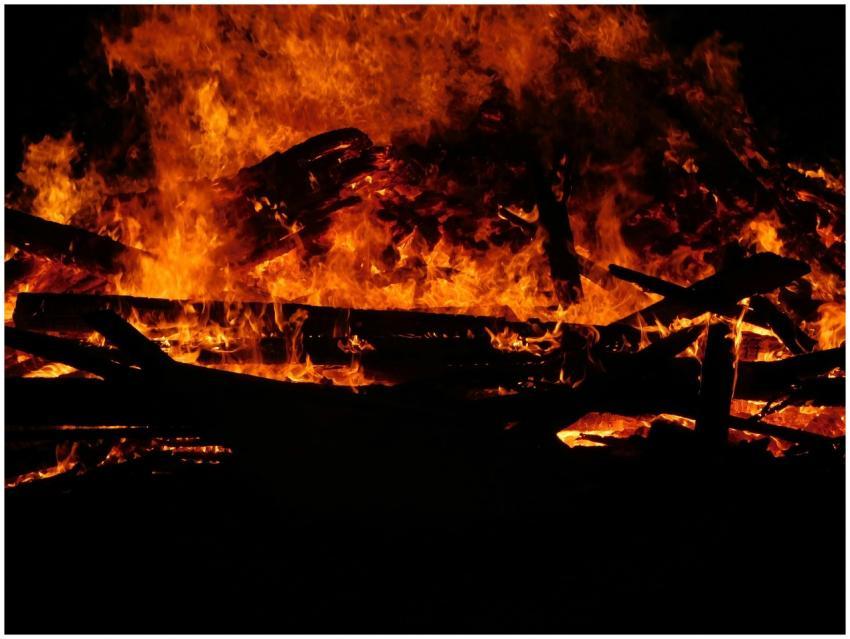 A dramatic close-up of a blazing bonfire, illumina