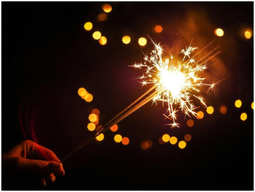 A vibrant sparkler glowing against a dark backgrou
