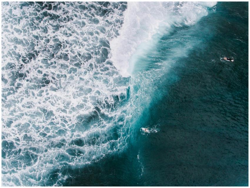 A breathtaking aerial shot capturing surfers amids