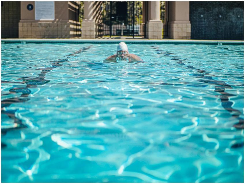 A swimmer practicing in an outdoor pool wearing go