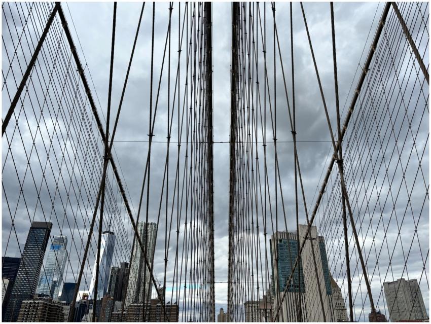 Gothic cables of Brooklyn Bridge with urban skylin