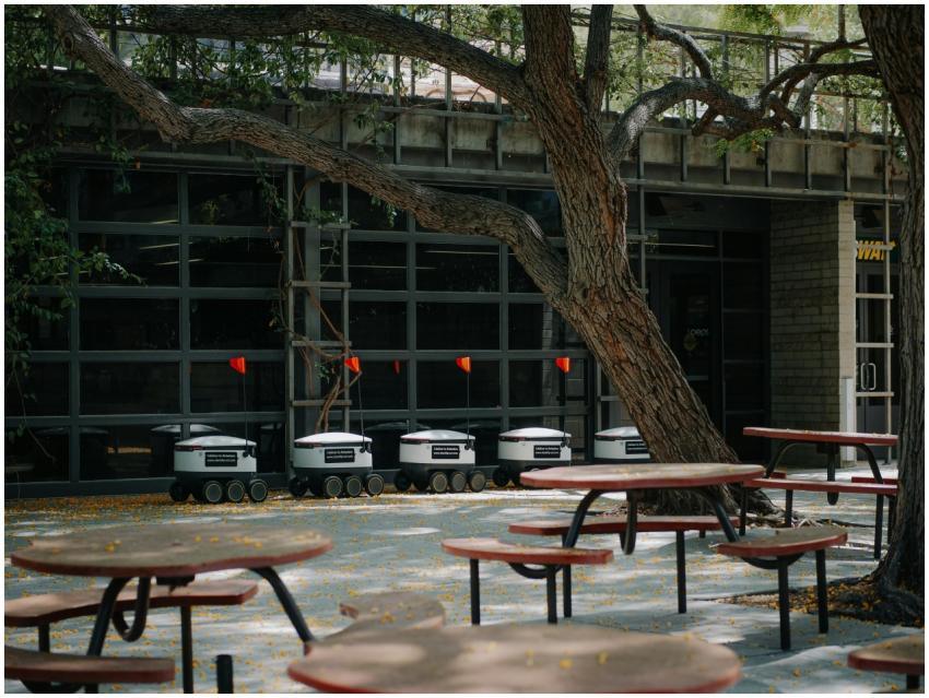 Autonomous delivery robots stationed outside in a