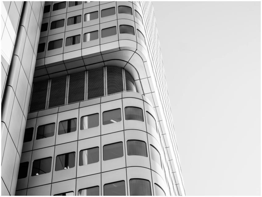 Grayscale photo of modern building facade in Frank