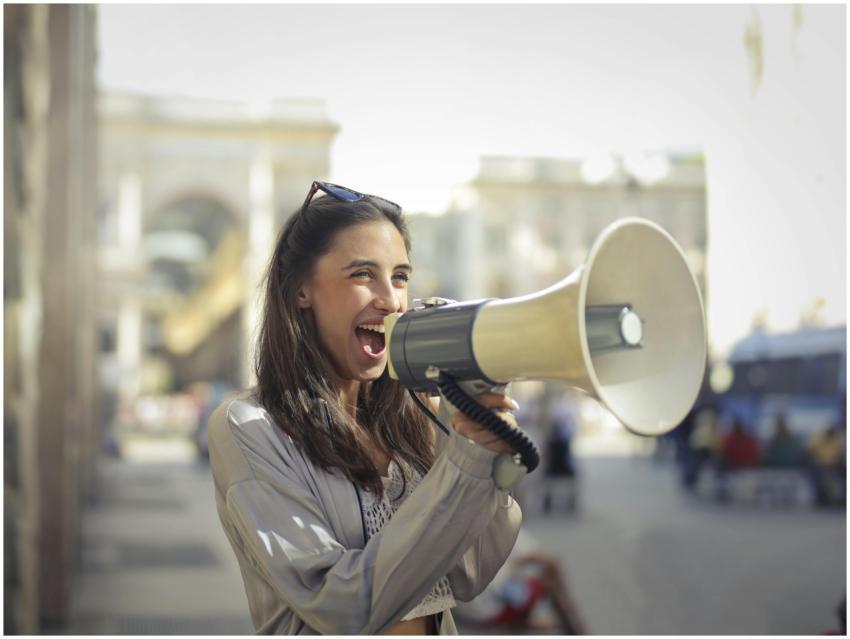 Cheerful young woman in a casual outfit shouting i