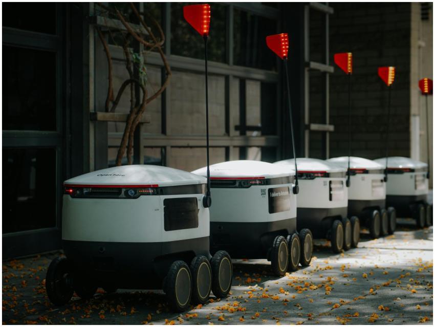 Futuristic delivery robots lined up in an urban en