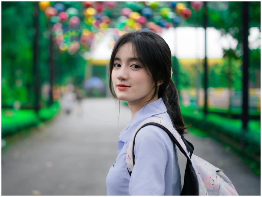 A young woman with a backpack looks back on a vibr