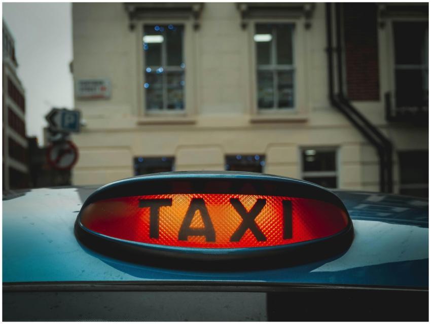 Close-up of an illuminated taxi sign against a Lon