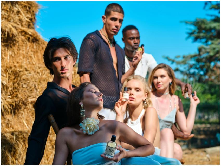 Stylish group modeling with perfume bottles outdoo