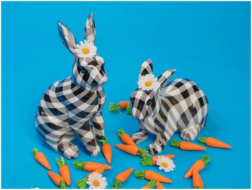 Playful checkered bunny figurines surrounded by ca
