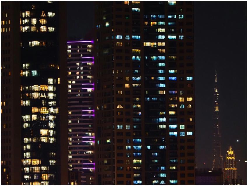 Skyscrapers at night with lights on, showcasing ur