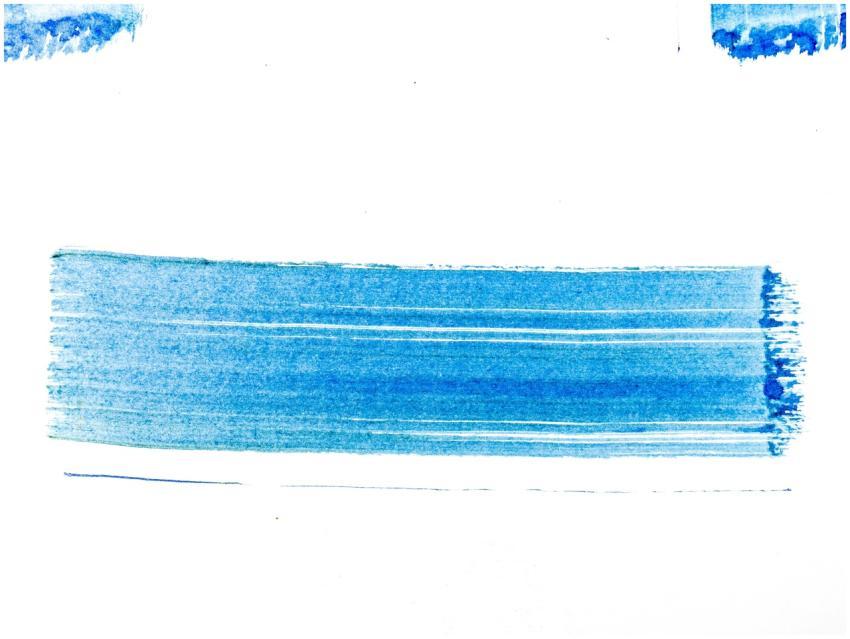 Abstract blue brushstroke on white paper creates a