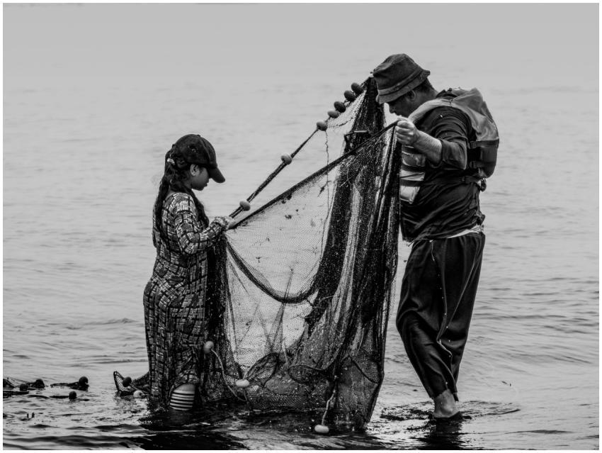A father and daughter fishing together on the Nile