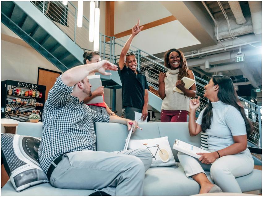 Energetic workplace meeting with diverse team coll