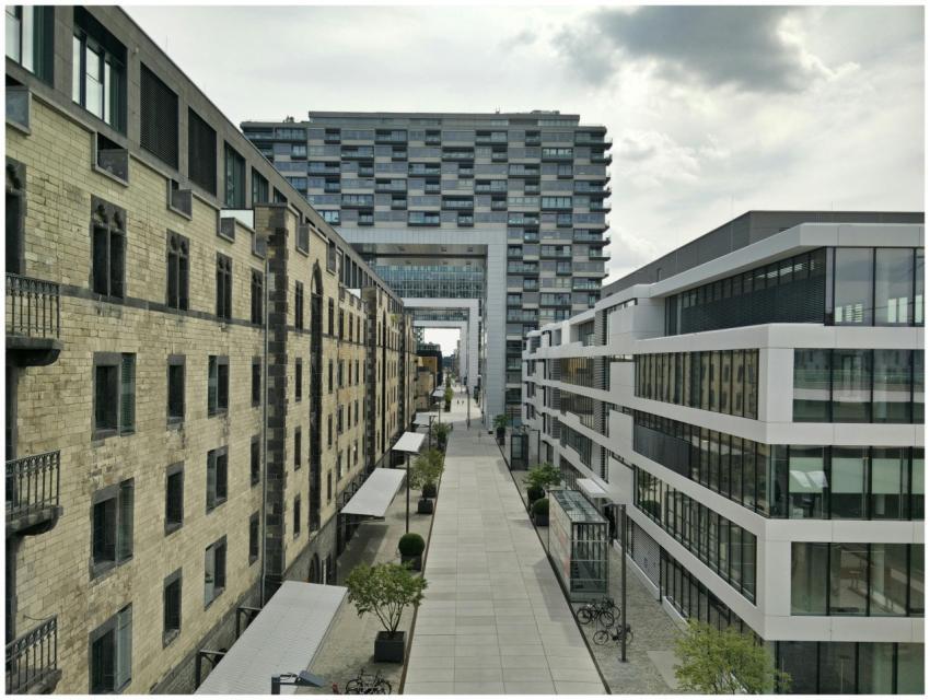 A vibrant urban street flanked by modern and histo