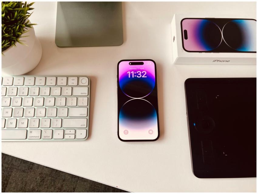 A sleek workspace setup featuring an iPhone with c