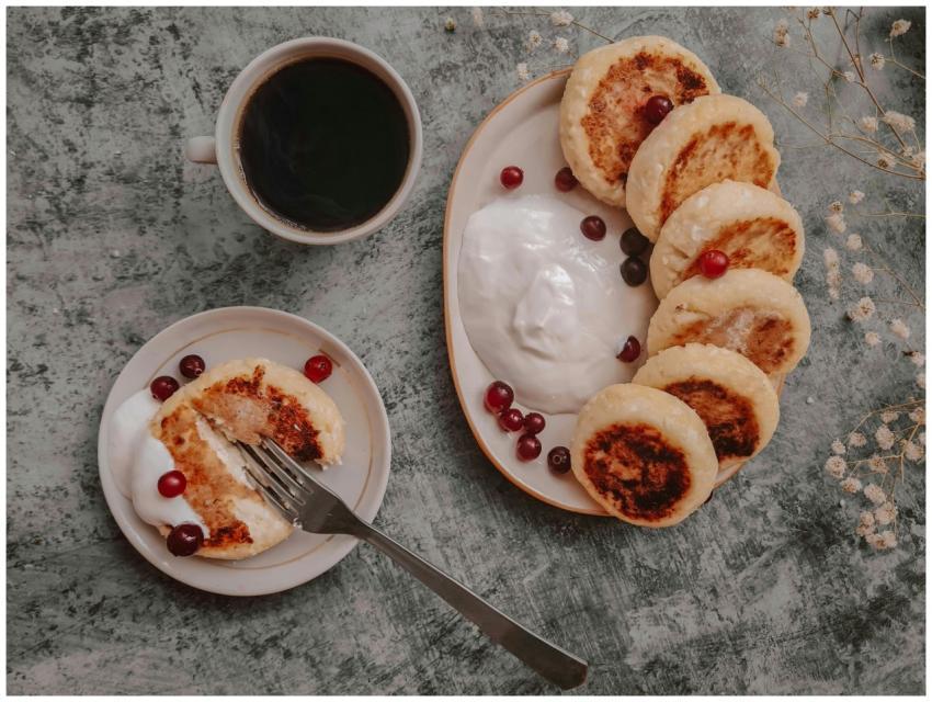 Rustic breakfast with syrniki pancakes, cranberrie