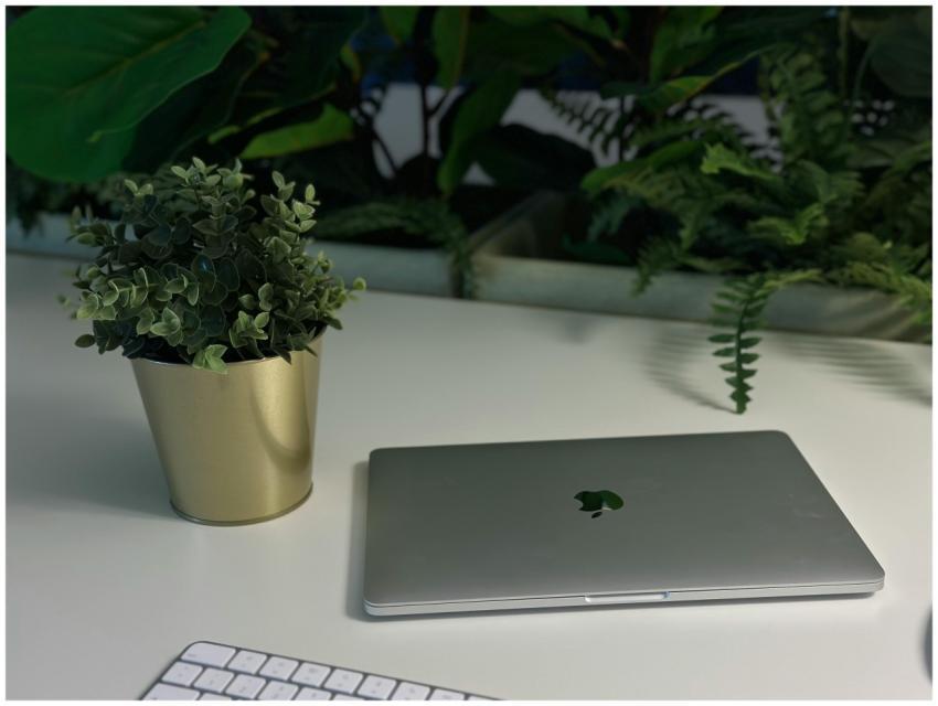 A clean and modern workspace featuring a laptop, k