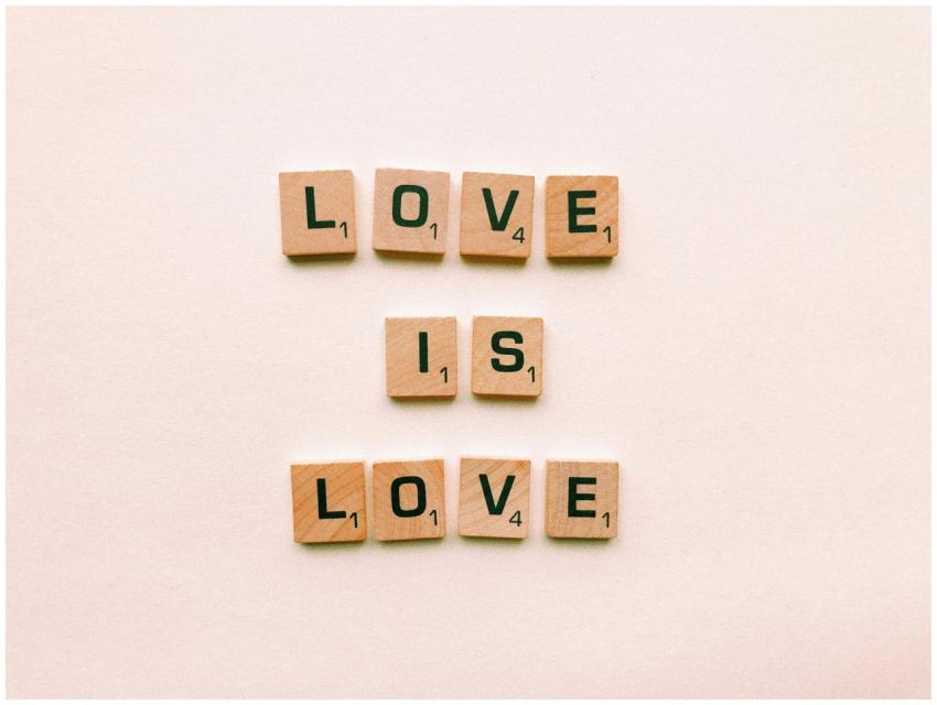 Wooden letter tiles forming 'Love is Love', symbol