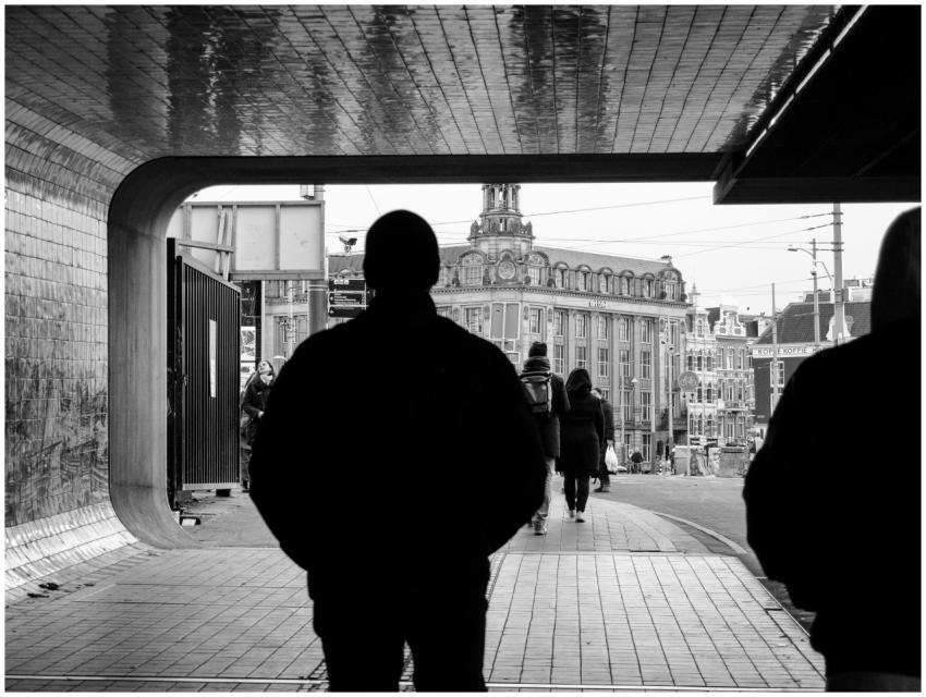Silhouettes walking through an Amsterdam tunnel wi