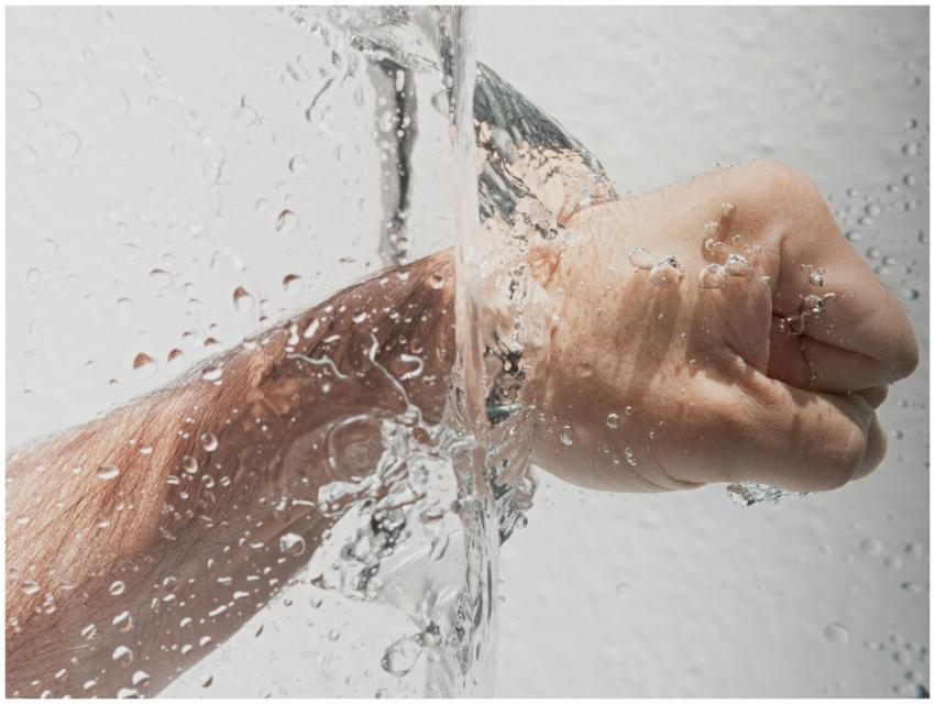 Dynamic image showing a clenched hand submerged in