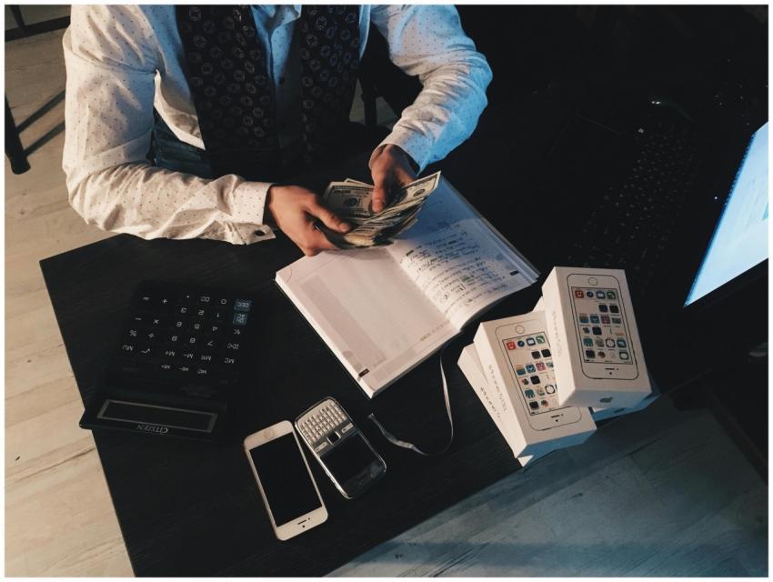 Businessman organizing finances with tech devices