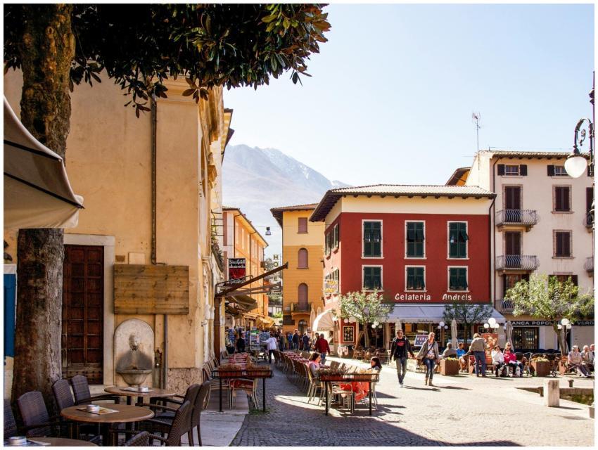 Picturesque Italian street with people enjoying su